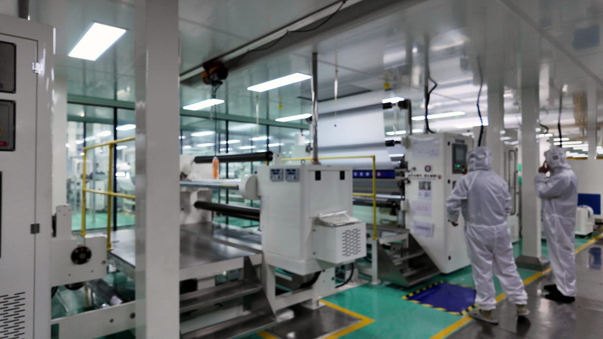 Cleanroom lamination line with operators in cleanroom suits