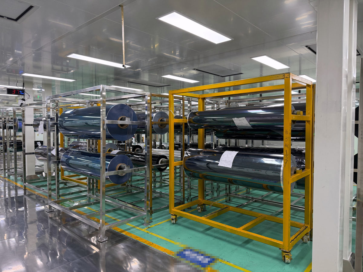 Master rolls staged on racks before slitting
