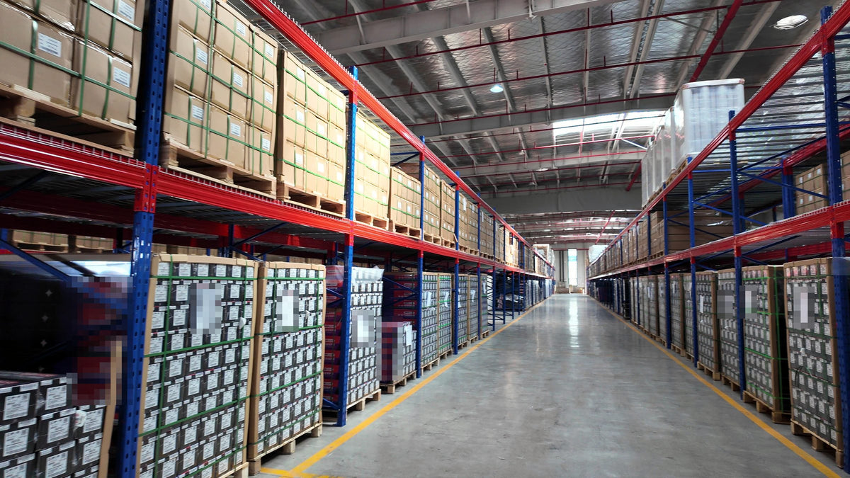 Finished-goods warehouse with packed film rolls on racking